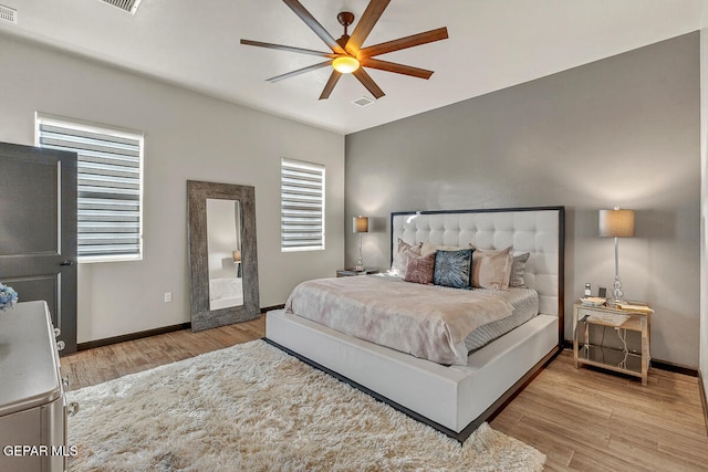 bedroom with ceiling fan and light hardwood / wood-style floors