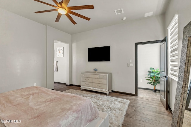 bedroom with ceiling fan and wood-type flooring