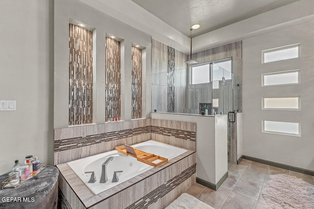 bathroom with tile patterned floors and shower with separate bathtub