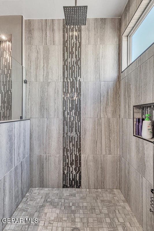 bathroom with tiled shower