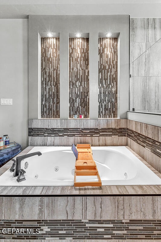 bathroom featuring tiled tub