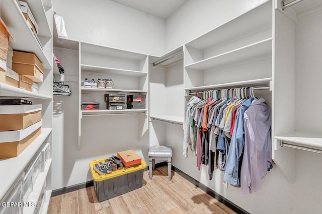 walk in closet with light wood-type flooring