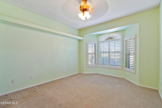 carpeted empty room with a textured ceiling and ceiling fan