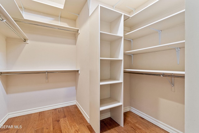 walk in closet featuring hardwood / wood-style floors