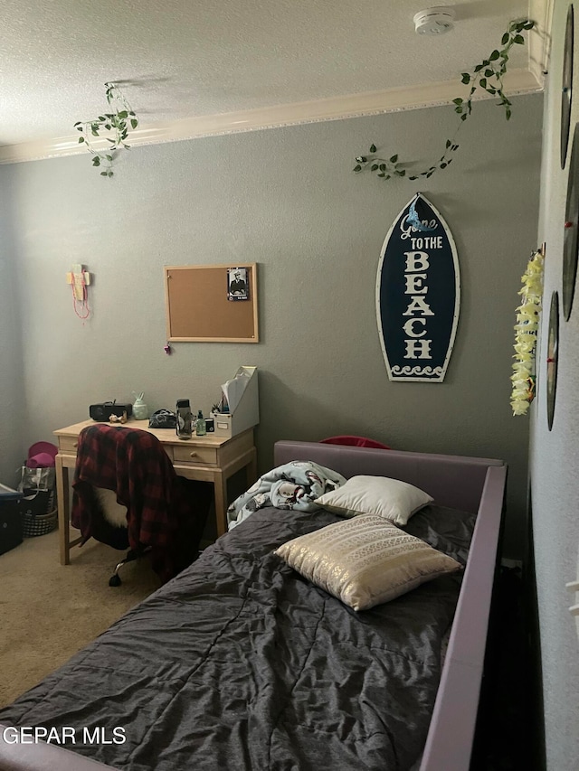 carpeted bedroom featuring crown molding and a textured ceiling