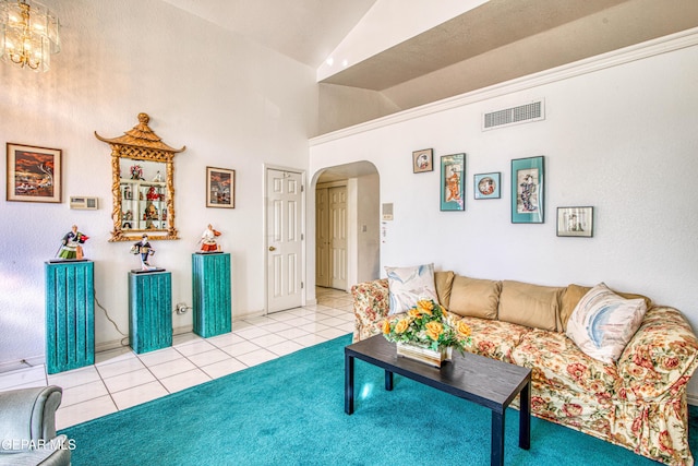 tiled living room featuring an inviting chandelier and lofted ceiling