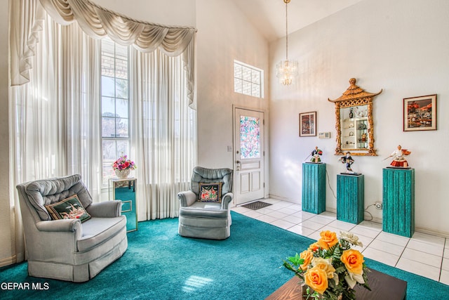 living area with lofted ceiling, a chandelier, light tile patterned floors, and plenty of natural light