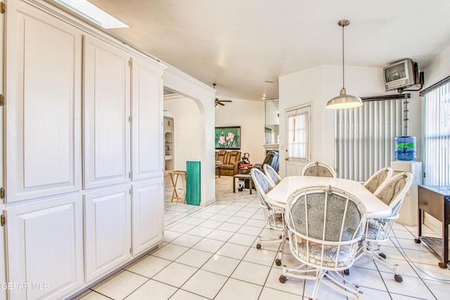 tiled dining space with ceiling fan