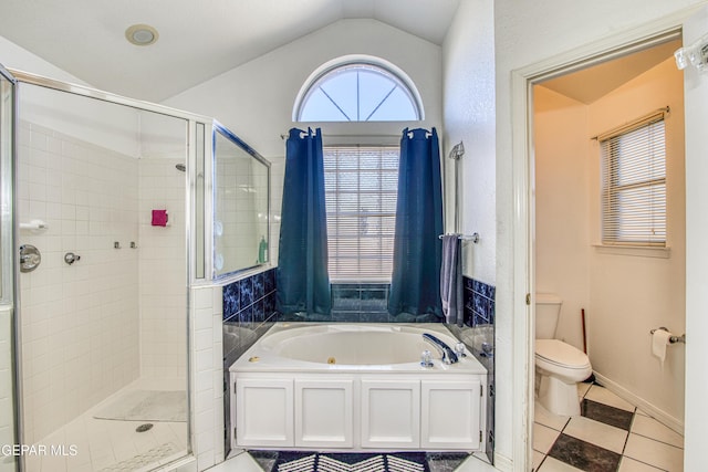 bathroom featuring independent shower and bath, tile patterned flooring, vaulted ceiling, and toilet