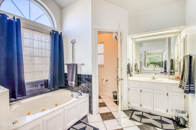 bathroom with vanity, tile patterned flooring, and a washtub