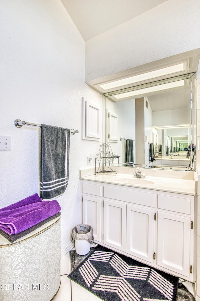 bathroom with tile patterned flooring and vanity