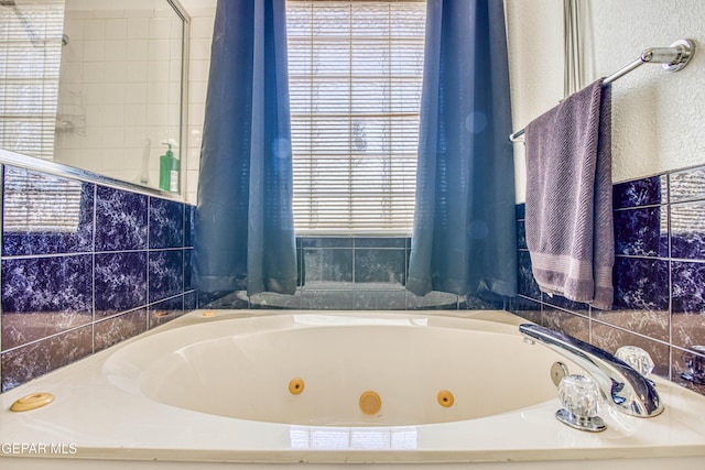 bathroom with a bath and a wealth of natural light