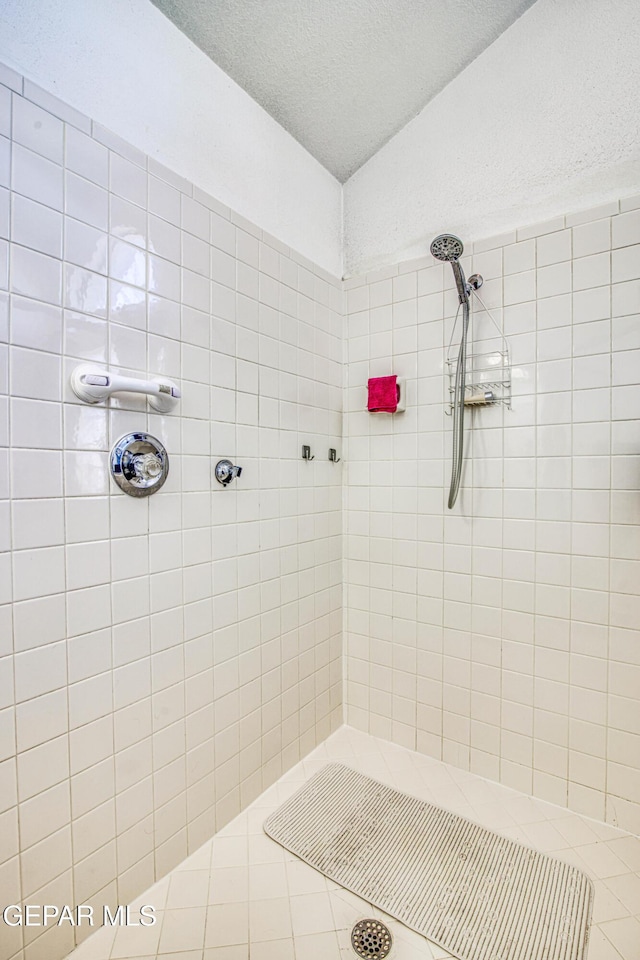 bathroom with a tile shower