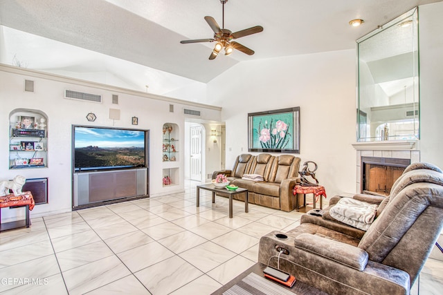 living room featuring lofted ceiling, built in shelves, ceiling fan, and a fireplace