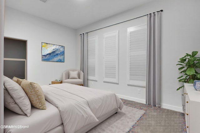 bedroom with baseboards and carpet floors
