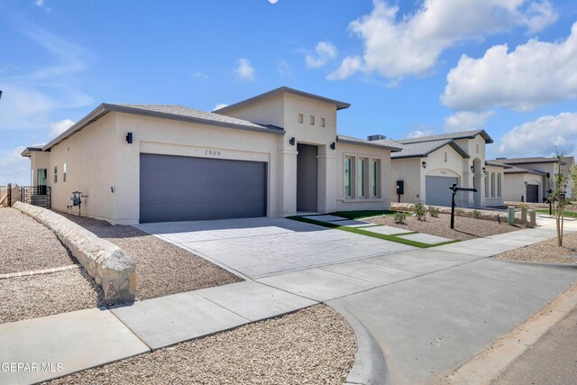 1800 Dana Gray St, El Paso, TX 79928 - contemporary house featuring driveway, stucco siding, and an attached garage