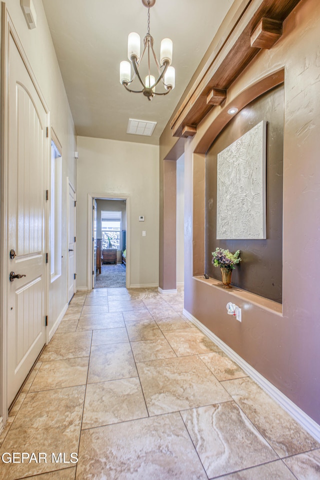 entrance foyer with a chandelier