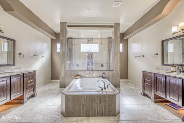 bathroom featuring tile patterned flooring, vanity, and separate shower and tub