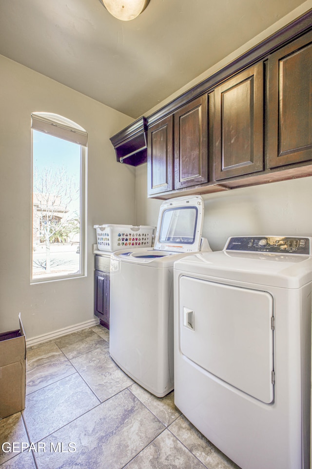 washroom featuring cabinets and washing machine and dryer