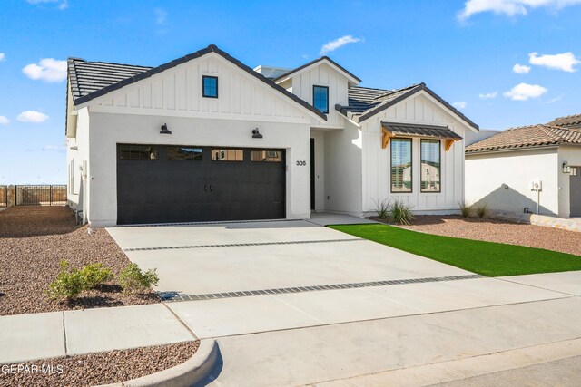 205 Playa Vista St, El Paso, TX 79928 - modern farmhouse with board and batten siding, a garage, concrete driveway, and fence