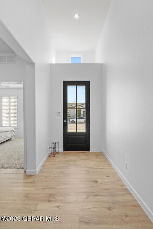 205 Playa Vista St, El Paso, TX 79928 - foyer entrance with healthy amount of natural light, wood finished floors, baseboards, a towering ceiling, and recessed lighting