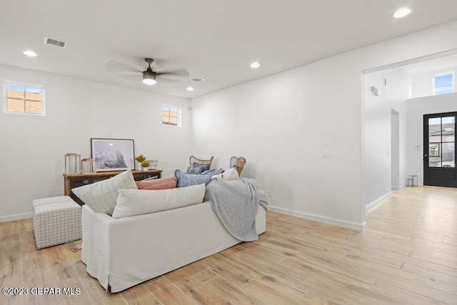 living room with ceiling fan and light wood-type flooring