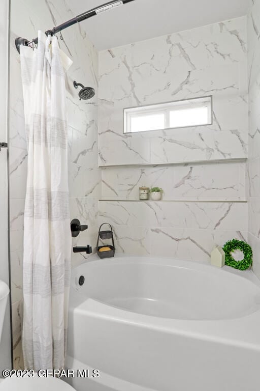 bathroom featuring shower / bath combination with curtain