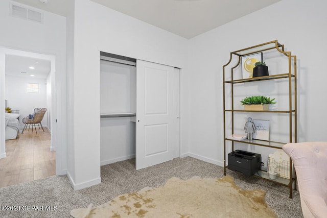 unfurnished bedroom featuring light wood-type flooring and a closet