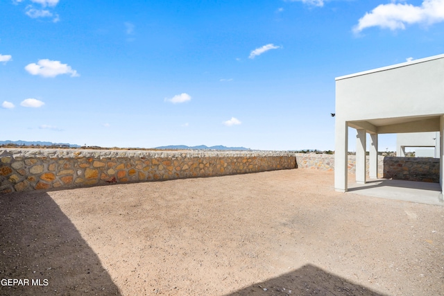 view of yard featuring a mountain view and a patio