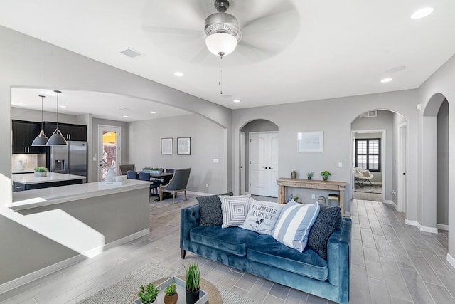 208 Playa Vista St, Horizon City, TX 79928 - living room with arched walkways, wood tiled floors, ceiling fan, baseboards, and recessed lighting