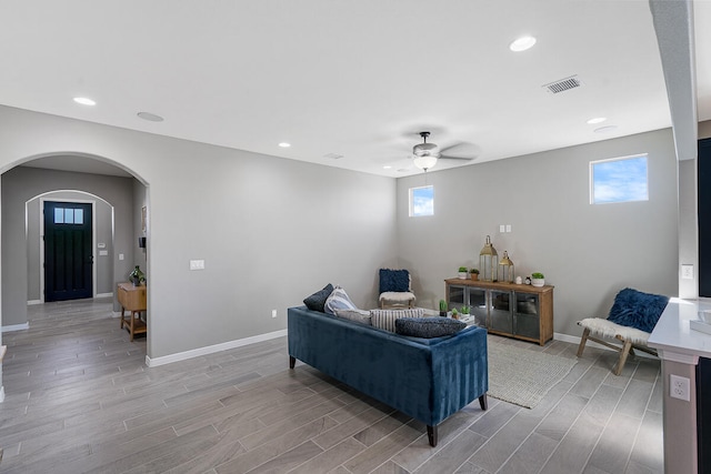 living room featuring light wood-type flooring, plenty of natural light, and ceiling fan