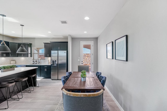 dining room featuring light hardwood / wood-style floors and sink