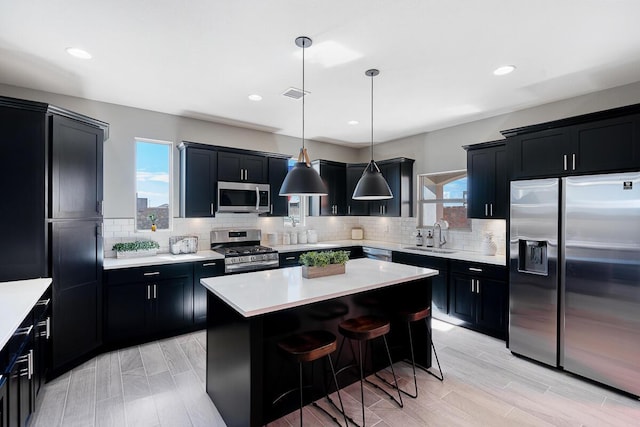208 Playa Vista St, Horizon City, TX 79928 - kitchen with appliances with stainless steel finishes, dark cabinets, a sink, light countertops, and recessed lighting