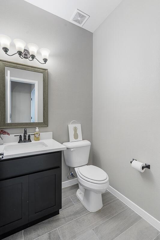 208 Playa Vista St, Horizon City, TX 79928 - bathroom with toilet, baseboards, and vanity