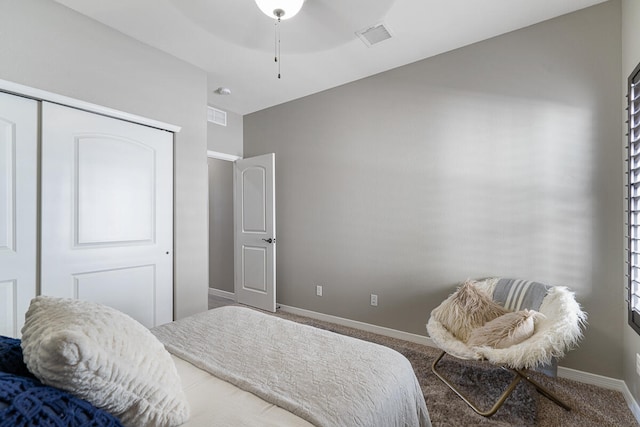 carpeted bedroom with a closet and ceiling fan