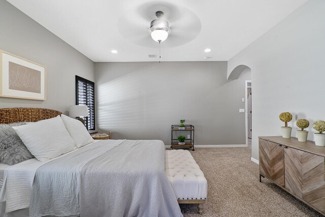 bedroom with ceiling fan and light carpet