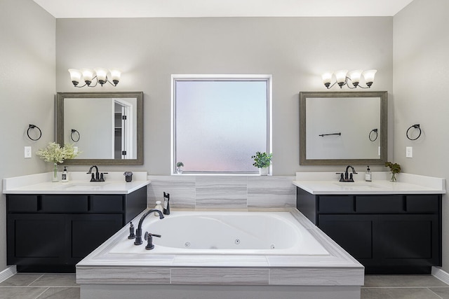 bathroom with tile patterned flooring, vanity, and tiled bath