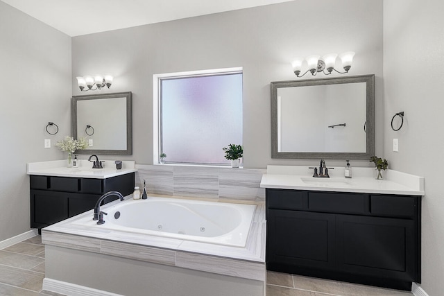 bathroom with tile patterned floors, tiled tub, and vanity