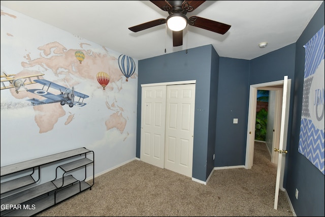 carpeted bedroom with a closet and ceiling fan