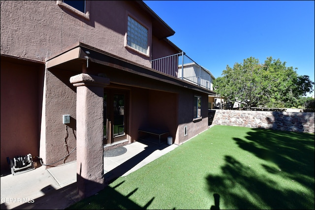 view of side of home featuring a yard