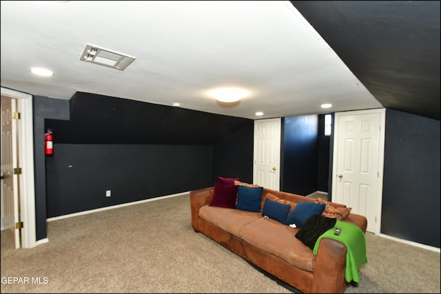 interior space featuring carpet floors and vaulted ceiling