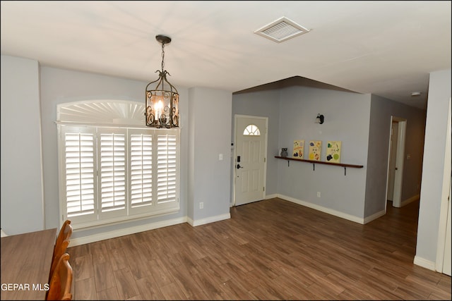 entryway featuring a chandelier and dark wood-type flooring