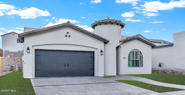 view of front of home with a front yard and a garage