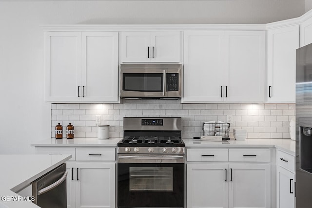 kitchen with white cabinetry, stainless steel appliances, and tasteful backsplash