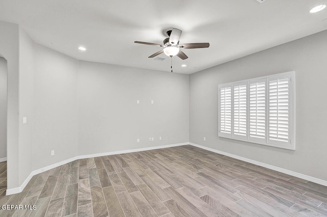 spare room with ceiling fan and light hardwood / wood-style floors