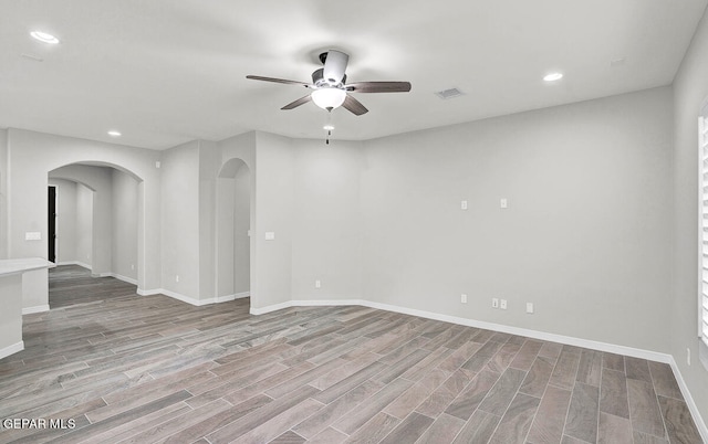 empty room featuring ceiling fan and light wood-type flooring