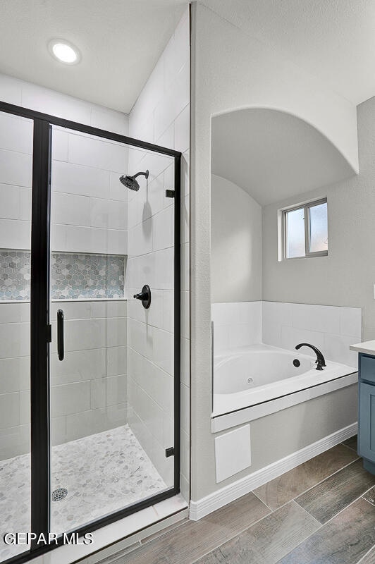 bathroom featuring vanity and plus walk in shower