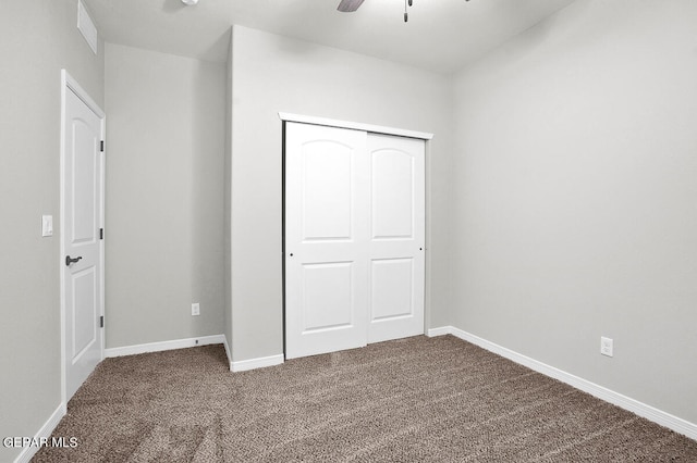 unfurnished bedroom featuring carpet flooring, ceiling fan, and a closet