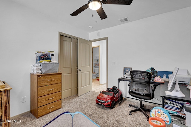 home office with ceiling fan and light colored carpet