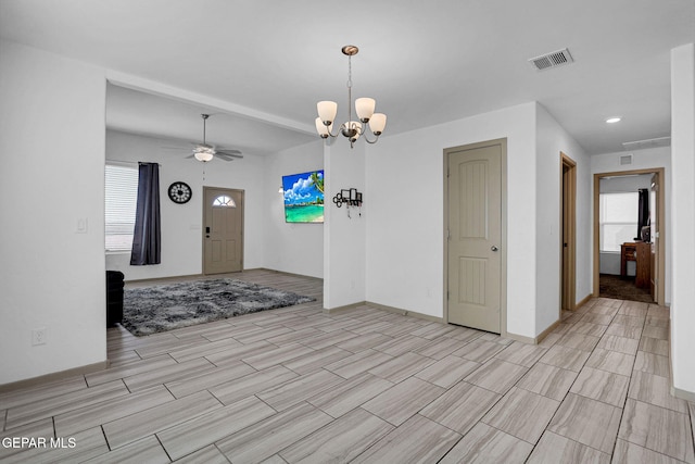 foyer featuring ceiling fan with notable chandelier and a wealth of natural light